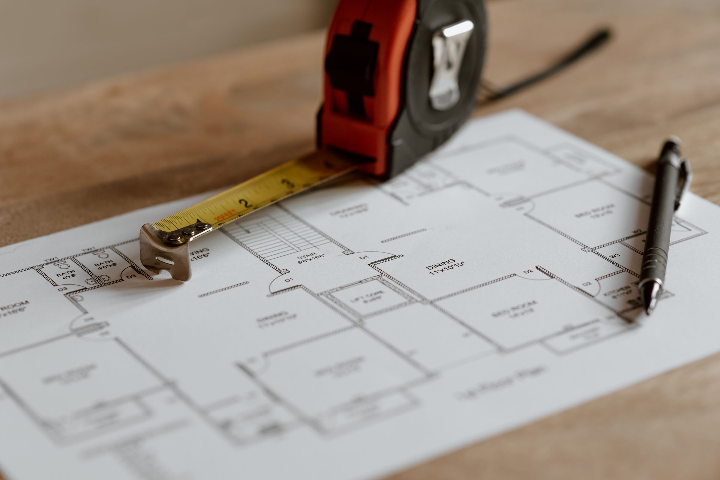 Heritage building plans with a tape measure during the planning stage
