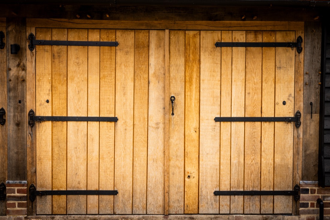 Oak double doors with black iron strap hinges