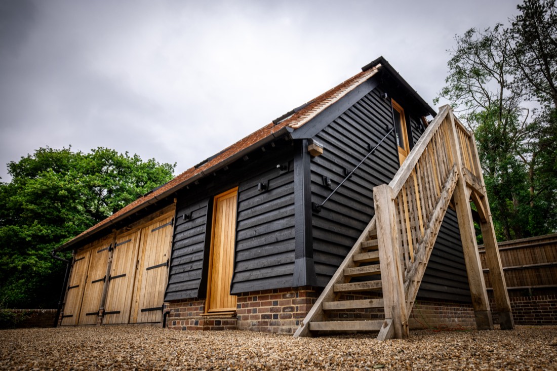 Oak framed garage with black weatherboarding