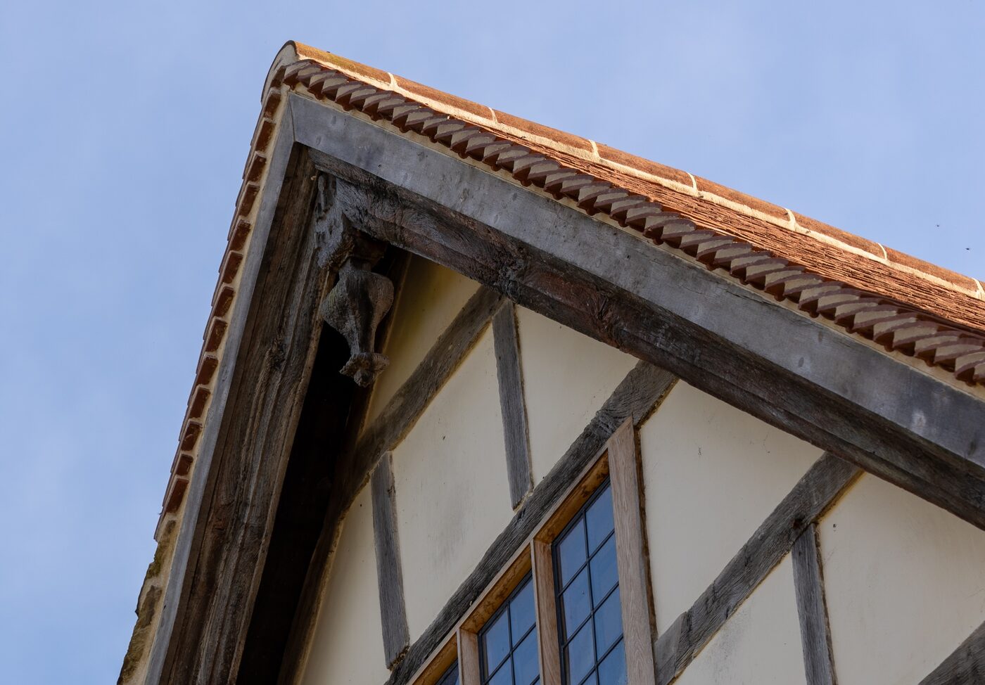 Lime render between the oak frame of a listed manor gable